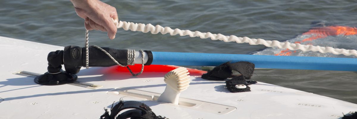 Person holding tensioned cable in the water