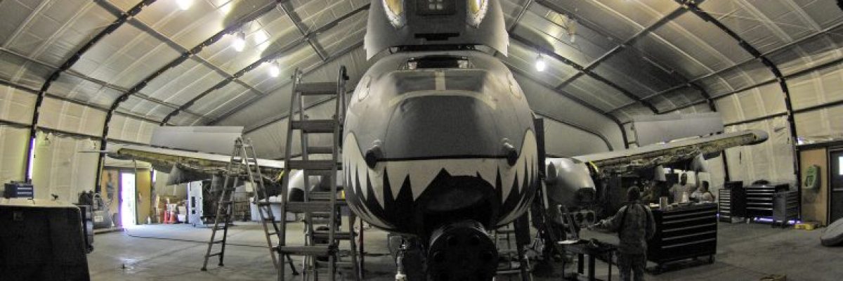 A fighter jet under maintenance parked in a hangar